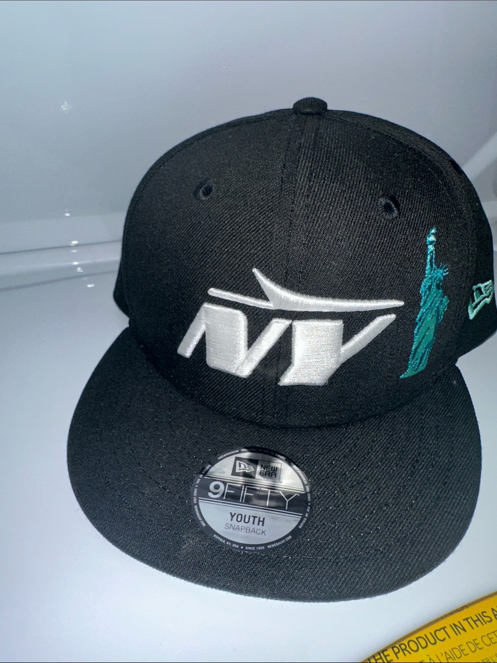 New Era Black Snapback Hat with White NY Logo and Teal Statue Accent